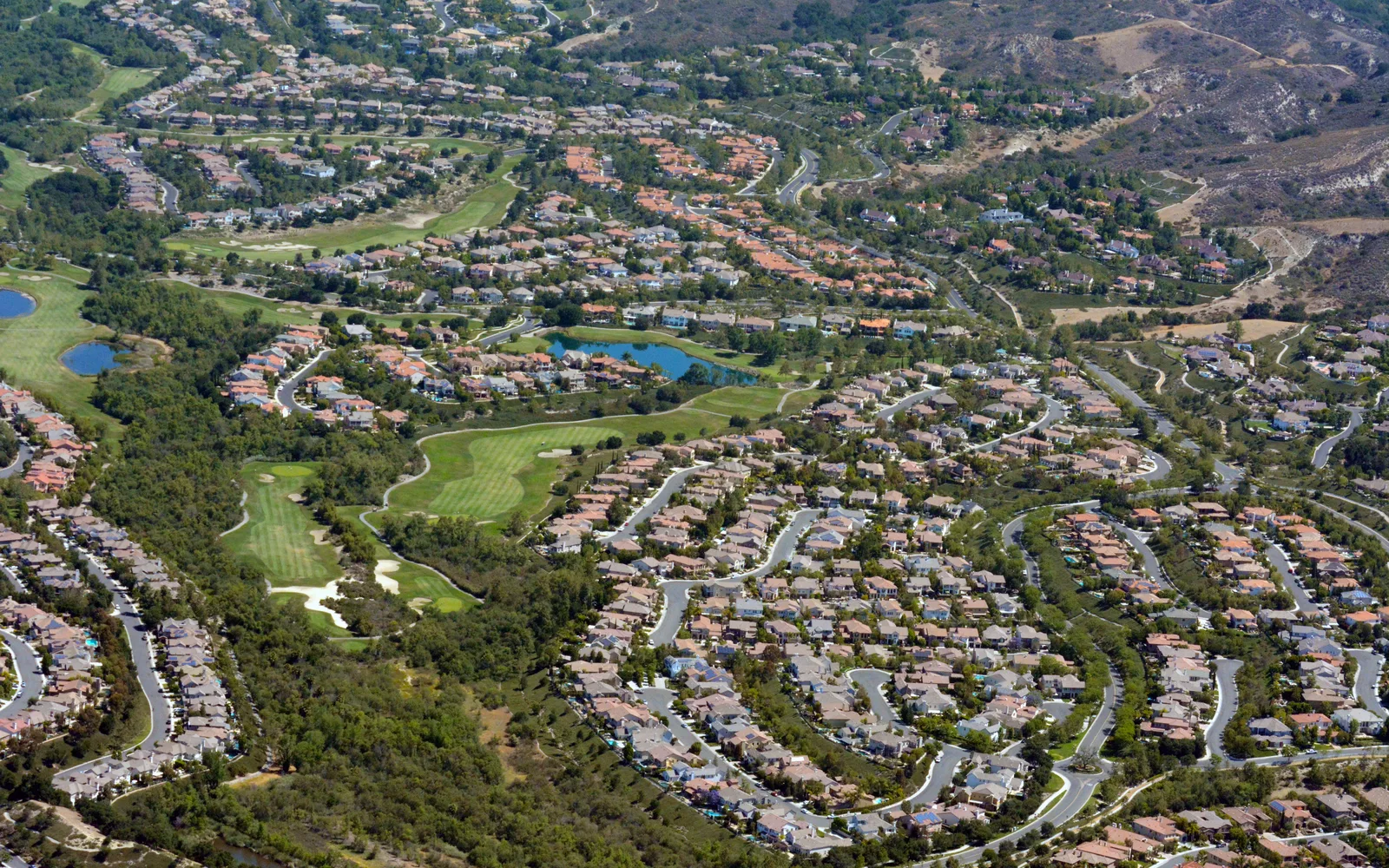 Aerial photograph of Ladera Ranch, a master-planned community in Orange County, showing planned neighborhood development with residential streets and green spaces